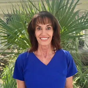 Cathy Forrester, Age in Place care manager, smiling outdoors.