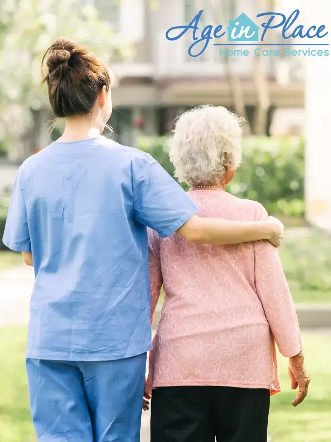 A caregiver supporting an elderly woman